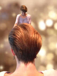 Up close portrait of back of a Root's Organic style woman's haircut