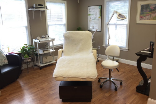view of the interior of the Roots Organic Hair Salon empty chair with well lit tables and chairs