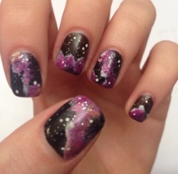 close up of nails painted with black and purple design