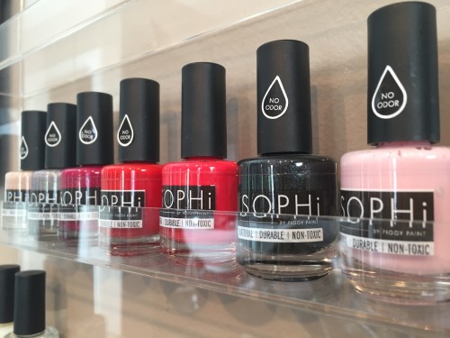 view of a display shelf with bottles of nail polish made by Sophi, in various shades